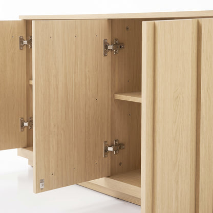 Partial view of an open light wood cabinet on a white background