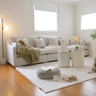 Light-colored sectional sofa styled in a bright living room