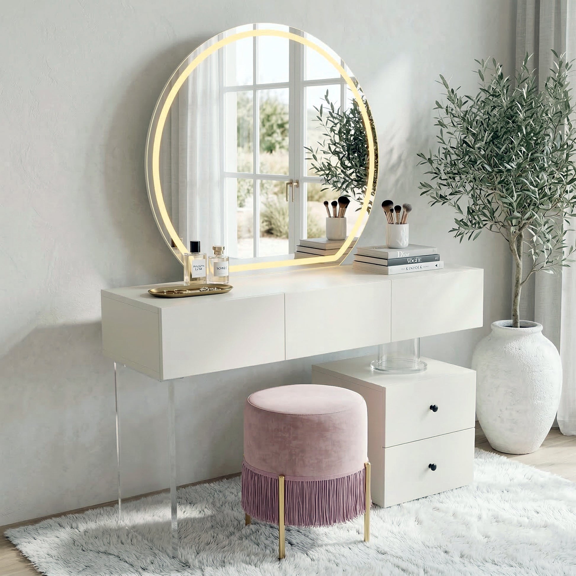 Styled vanity area with white table, round LED mirror, pink stool, and décor in a modern room
