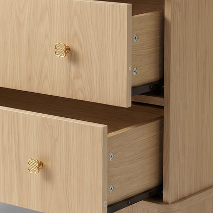 Close-up of two open drawers and gold knobs showing interior and slides on plain background