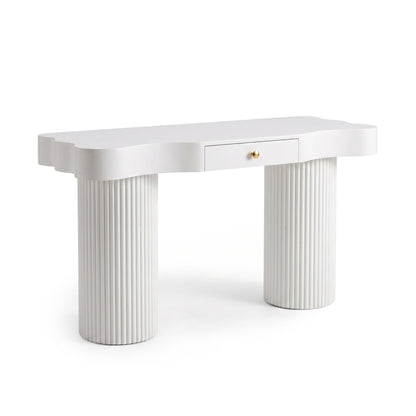 White modern console table with scalloped edge top, fluted cylindrical legs, and a gold knob drawer on a white background
