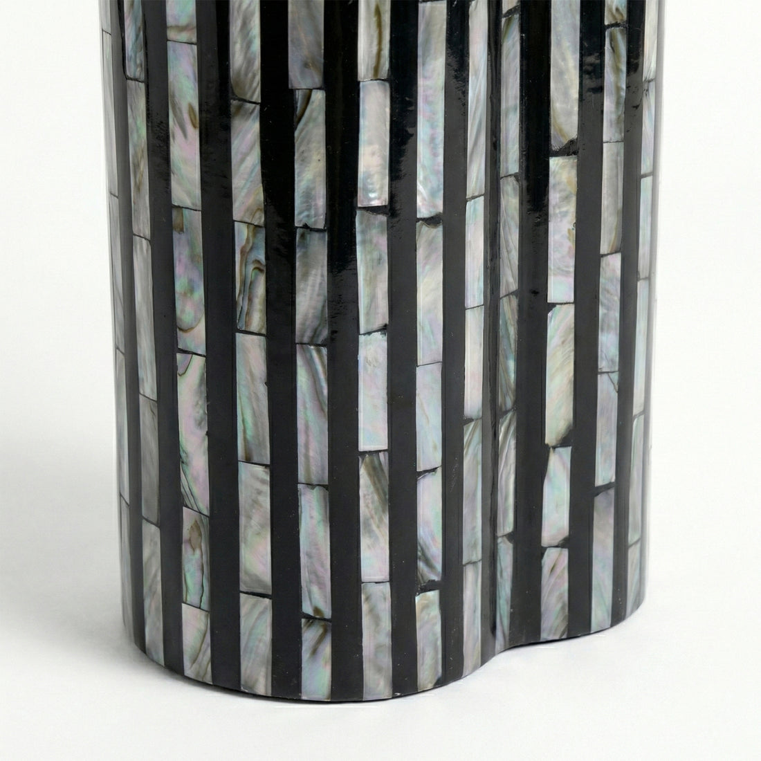 Close-up of reflective shell and black stripe mosaic pattern on white background