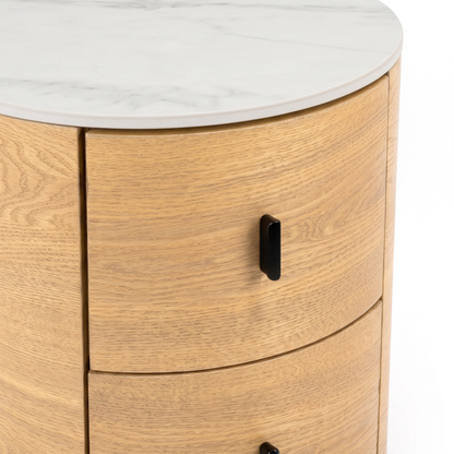 Partial view of a round wooden side table with marble-look top on white background