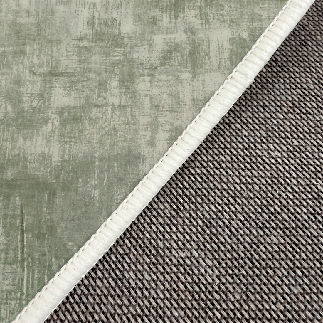 Close-up of rug corner showing texture, stitching, and backing