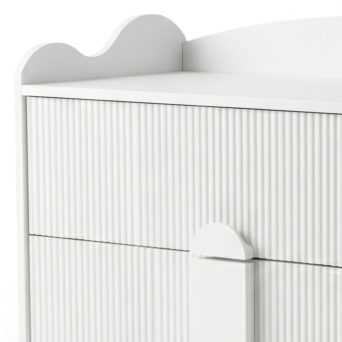 Upper section of white dresser with grooved texture and scalloped top edge
