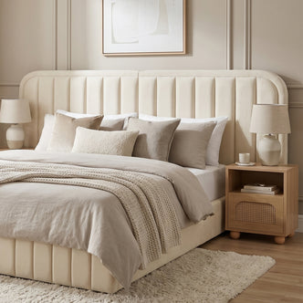 Modern upholstered bed with cream headboard in a styled bedroom