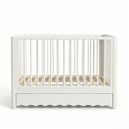 White modern baby crib on white background with wavy base detailing