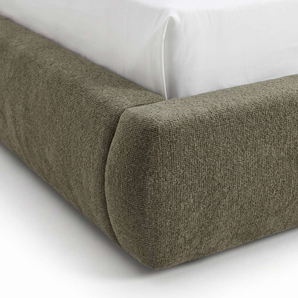 Close-up of upholstered bed frame corner with textured fabric