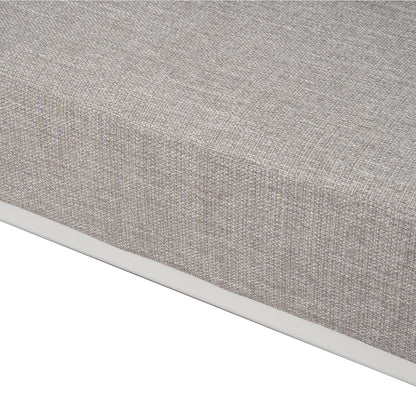 Close-up of the corner and fabric texture of a mattress or cushion on a white background.