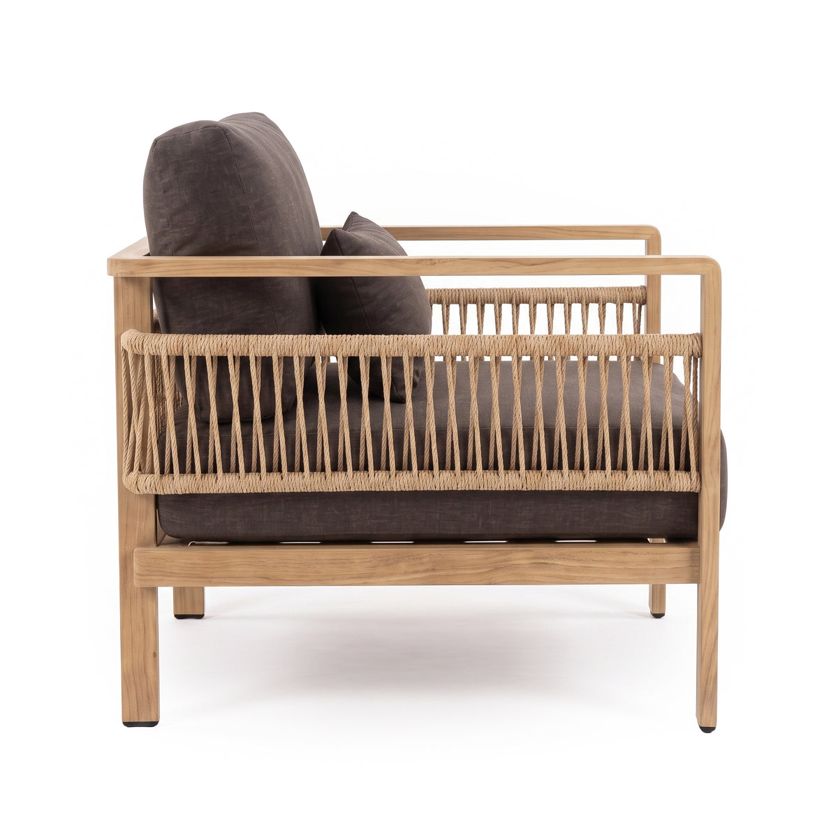 Side view of a modern armchair with wood frame and dark cushions on white background