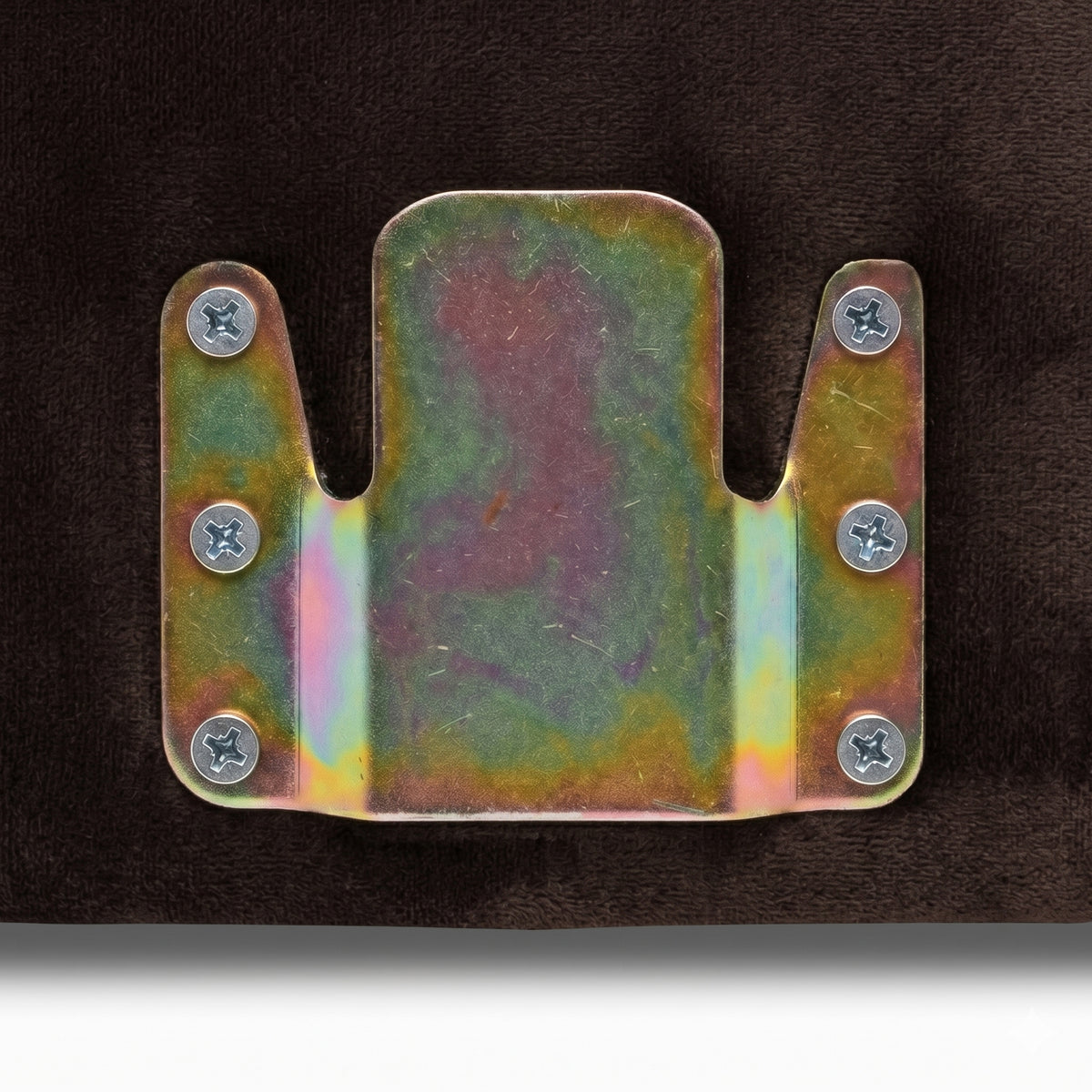 Close-up of metal bracket attached to dark fabric