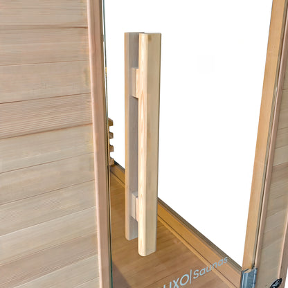 Close-up of a wooden sauna door handle and paneling