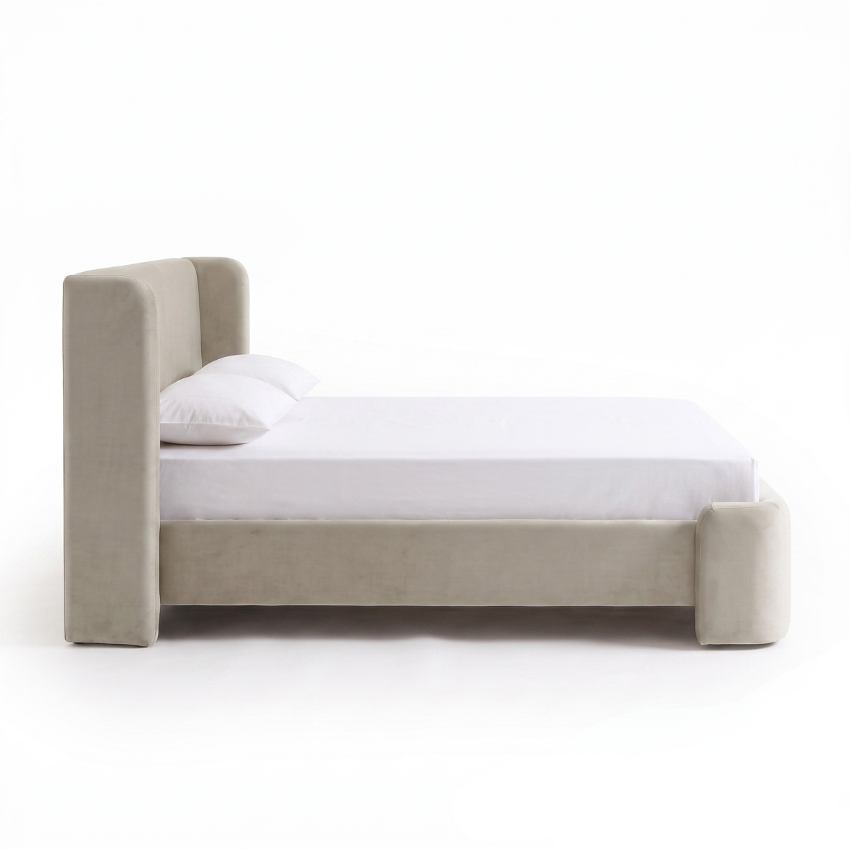 Side profile view of an upholstered bed on a white background
