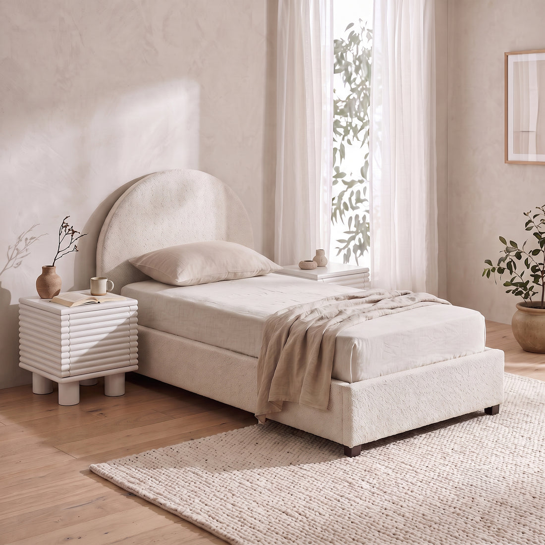 Cream bouclé single bed with an arched headboard and matching textured nightstand.