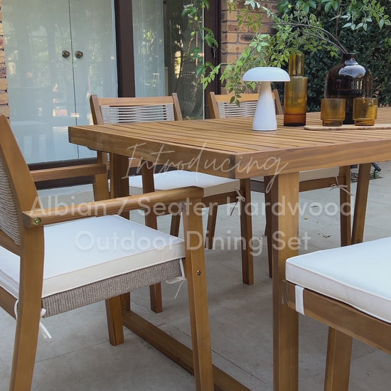 Timber outdoor dining set with cushioned chairs on garden patio