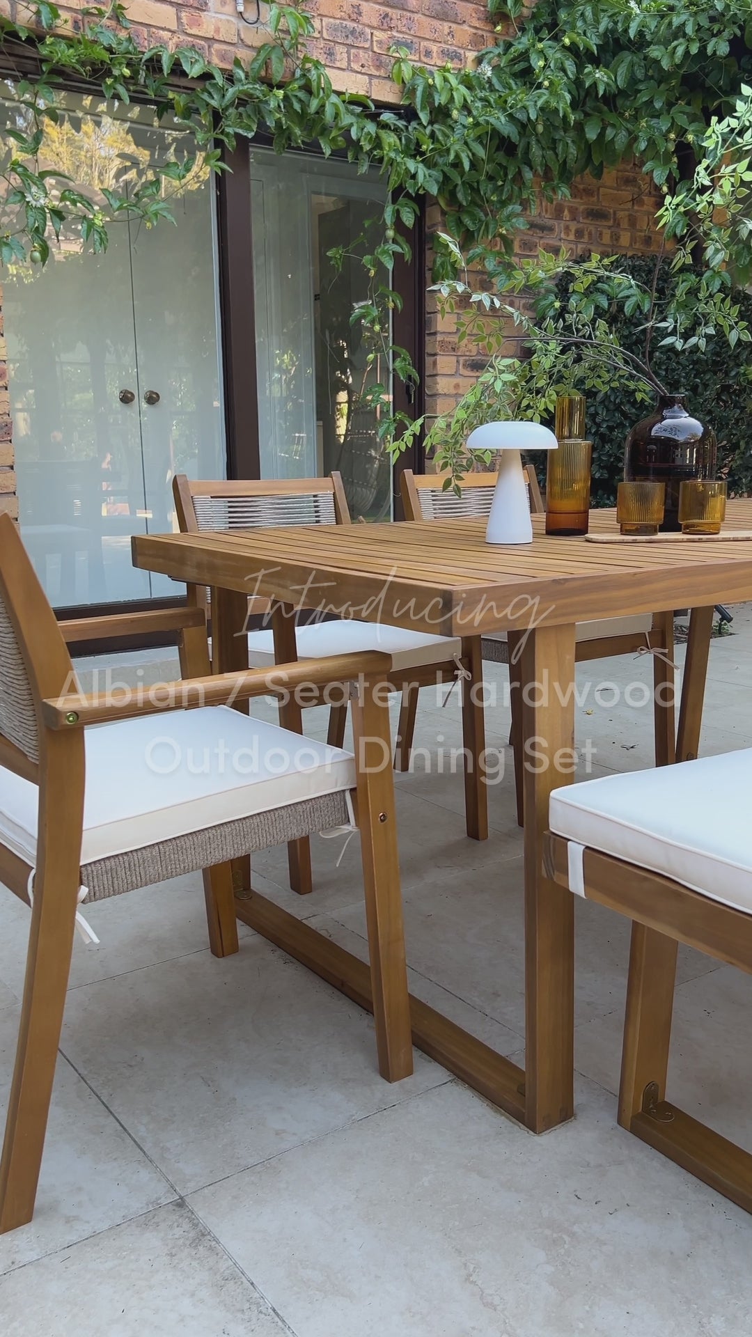 Timber outdoor dining set with cushioned chairs on garden patio